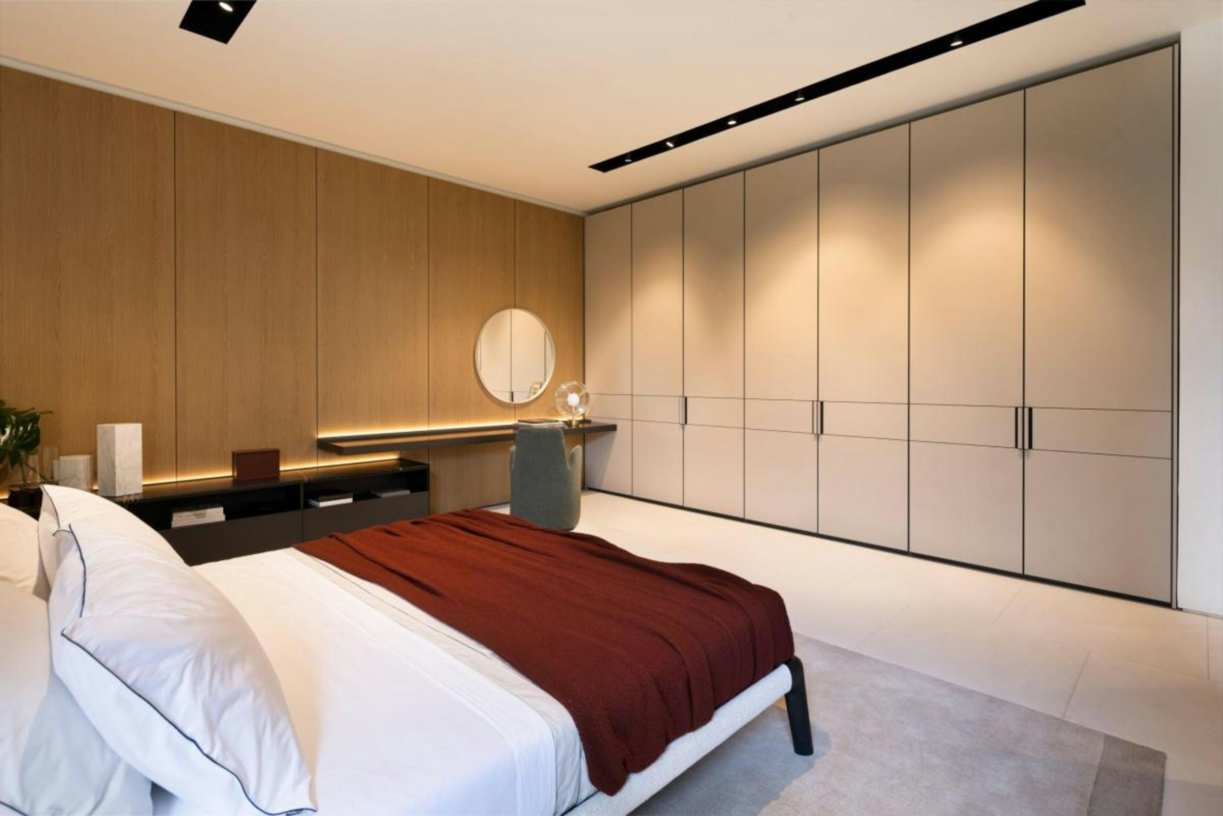 Calm modern bedroom interior with thoughtful lighting and furnishings
